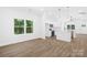Open-concept living room and kitchen with hardwood floors and modern finishes create a seamless living space at 332 Hollingswood Dr, Statesville, NC 28625