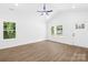 Bright, empty living room features high ceilings, wood-look flooring, and large windows at 332 Hollingswood Dr, Statesville, NC 28625