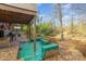 Inviting back deck with green benches and a tranquil view of the wooded backyard at 335 Summit Se Ct, Concord, NC 28025