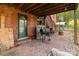 Backyard brick patio featuring a backyard grill and wooden staircase at 335 Summit Se Ct, Concord, NC 28025