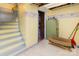A yellow and brick basement room features wooden stairs and a doorway view at 335 Summit Se Ct, Concord, NC 28025