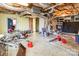 A basement with exposed ceiling and duct work holds a collection of lawn care equipment at 335 Summit Se Ct, Concord, NC 28025