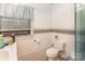 Bathroom with a toilet, sink, and a window with blinds at 335 Summit Se Ct, Concord, NC 28025