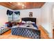 Bedroom with a wooden plank ceiling, white walls, and a tufted headboard at 335 Summit Se Ct, Concord, NC 28025