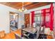 Elegant dining room with modern table set, wood ceiling, and ample natural light from the window at 335 Summit Se Ct, Concord, NC 28025