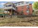 Back exterior featuring a covered porch, brick facade, and stairs leading to the yard at 335 Summit Se Ct, Concord, NC 28025