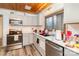Well-lit kitchen with stainless steel appliances, modern fixtures, and ample countertop space at 335 Summit Se Ct, Concord, NC 28025