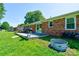 Backyard view of the deck and house with a grill and firewood at 3413 Fallston Rd, Shelby, NC 28150