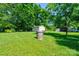 A backyard featuring a well, a shed, and mature trees at 3413 Fallston Rd, Shelby, NC 28150