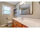 Bright bathroom with a wooden vanity, toilet, shower with a curtain, and a window for natural light at 3413 Fallston Rd, Shelby, NC 28150