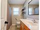 Bright bathroom with a wooden vanity, toilet, shower with a curtain, and a window for natural light at 3413 Fallston Rd, Shelby, NC 28150