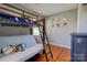 A bedroom with a bunk bed, hardwood floors, and a decorative wall at 3413 Fallston Rd, Shelby, NC 28150