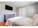 Clean bedroom features include a TV, closet, and a light-colored bedspread, providing a tidy and simple space at 3413 Fallston Rd, Shelby, NC 28150
