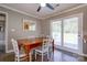 Cozy dining room features a wooden table, natural light from the sliding glass door, and neutral wall colors at 3413 Fallston Rd, Shelby, NC 28150