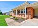 Inviting front porch with hanging plants and a brick facade at 3413 Fallston Rd, Shelby, NC 28150