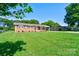 Traditional brick home featuring a green lawn and inviting covered entry at 3413 Fallston Rd, Shelby, NC 28150