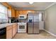 Well-equipped kitchen with stainless steel refrigerator and wood cabinetry at 3413 Fallston Rd, Shelby, NC 28150