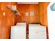 A utility room with wood paneling and washer and dryer at 3413 Fallston Rd, Shelby, NC 28150