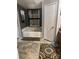 Bathroom featuring a soaking tub, neutral-tone floors, and large decorative mirror at 456 Cornelius Rd, Mooresville, NC 28117