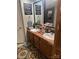 Bathroom featuring double sinks, terracotta countertops, and decorative artwork on the walls at 456 Cornelius Rd, Mooresville, NC 28117