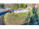Aerial view of a charming single-story home with a well-maintained lawn and a utility truck in the drive at 456 Cornelius Rd, Mooresville, NC 28117