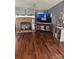 Comfortable living room with a brick fireplace, entertainment center, and hardwood floors at 456 Cornelius Rd, Mooresville, NC 28117