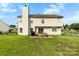 Well-maintained backyard with a brick patio, fenced yard, and a traditional two-story house at 4612 Maple Crest Pl, Harrisburg, NC 28075