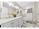 Bright bathroom with double sinks, white cabinets, and a shower/tub combo at 4612 Maple Crest Pl, Harrisburg, NC 28075
