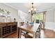 Light filled dining room with hardwood floors, large windows, and stylish light fixture at 4612 Maple Crest Pl, Harrisburg, NC 28075