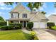 Charming two-story home with a well-manicured lawn, blue shutters, and a two-car garage at 4612 Maple Crest Pl, Harrisburg, NC 28075