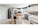 Modern kitchen with white cabinets, stainless steel appliances, and a center island with seating at 4612 Maple Crest Pl, Harrisburg, NC 28075