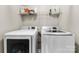 Neat laundry room featuring a modern, front-loading washer and dryer and practical shelf storage at 4612 Maple Crest Pl, Harrisburg, NC 28075