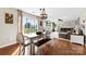 Inviting living room with hardwood floors, large windows, and adjacent seating area at 4612 Maple Crest Pl, Harrisburg, NC 28075