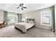 Spacious main bedroom boasts a tray ceiling, ceiling fan, and plenty of natural light at 4612 Maple Crest Pl, Harrisburg, NC 28075