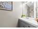 Cozy powder room featuring a gray vanity with modern fixtures at 4612 Maple Crest Pl, Harrisburg, NC 28075