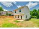 Back of a two-story white home with black roof and green trees under a blue sky at 463 W Barr St, Lancaster, SC 29720