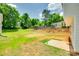 A lush, partially-fenced green backyard with a new concrete patio and a grassy area at 463 W Barr St, Lancaster, SC 29720