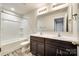 Bathroom features a double sink vanity with dark cabinets and a tub and shower combination at 463 W Barr St, Lancaster, SC 29720