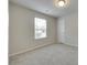This bedroom features neutral walls, plush carpet, a bright window, and a door for easy access at 463 W Barr St, Lancaster, SC 29720