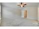 Large bedroom featuring a ceiling fan, neutral carpet, and ample natural light at 463 W Barr St, Lancaster, SC 29720