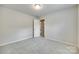 The bedroom has neutral paint, new carpet, an overhead light, and an open door to the hallway at 463 W Barr St, Lancaster, SC 29720