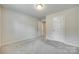 Bedroom with neutral carpet and white walls leading to other rooms at 463 W Barr St, Lancaster, SC 29720