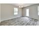 Cozy dining space with modern chandelier, neutral walls, and stylish wood-look flooring, great for Gathering meals at 463 W Barr St, Lancaster, SC 29720
