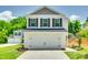 Two-story home featuring a two-car garage with white doors and black hardware and a well-maintained front yard at 463 W Barr St, Lancaster, SC 29720