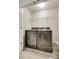 Laundry room with side-by-side washer and dryer, gray plank flooring and wire shelf at 463 W Barr St, Lancaster, SC 29720