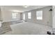 Spacious living room with neutral carpeting, bright natural light, and stylish wood-look flooring accents at 463 W Barr St, Lancaster, SC 29720