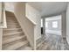 Carpeted staircase leading to the second floor, complemented by gray walls and wood-look flooring at 463 W Barr St, Lancaster, SC 29720