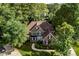 An elevated view showcases this beautiful brick home surrounded by lush greenery and mature trees at 5310 Addington Ct, Charlotte, NC 28277