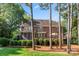 Large backyard view of two-story brick home, including deck and screened porch at 5310 Addington Ct, Charlotte, NC 28277
