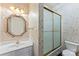 Bathroom with bright wallpaper and a combined shower and bathtub behind a frosted glass door at 5310 Addington Ct, Charlotte, NC 28277